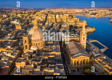 Valletta, Malta - Our Lady of Mount Carmel Church and St.Paul's Cathedral from above at sunrise with the ancient city of Valletta at background Stock Photo