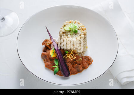 Stewed chicken hearts with barley Stock Photo