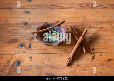 Cinnamon and pepper arranged on a old table Stock Photo