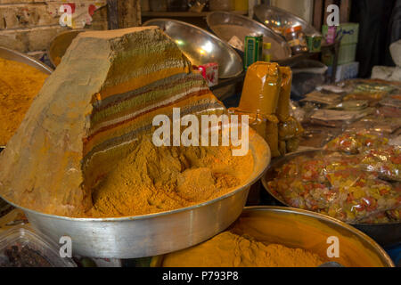 A colourful display of layered and sectioned cooking powders and spices in bowls on a middle eastern market stall. Stock Photo