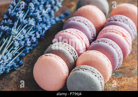 Freshly baked multi-colored macaroons close-up, selective focus. Stock Photo