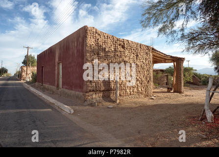 Vinchina, La Rioja, Argentina - 2018: View of typical adobe houses on the town main road. Most houses in this arid region are made of adobe. Stock Photo