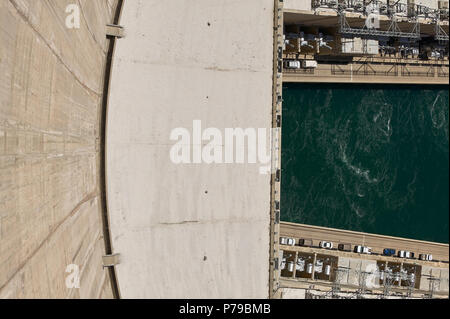 Dramatic High Angle View Looking Down Curved Wall at Green Water of Colorado River and Hydroelectric Equipment from top of Hoover Dam, Arizona Nevada  Stock Photo