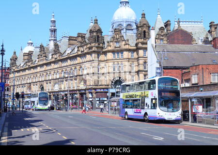 New Market Street is a popular bus route in Leeds City Centre with Kirkgate Market as a backdrop. Stock Photo