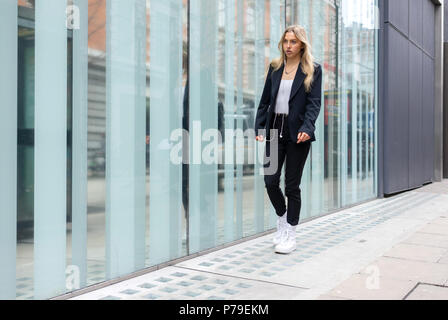 Teenage girl walking on a London street Stock Photo