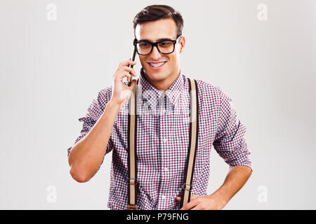 Nerdy man talking on the phone. Stock Photo