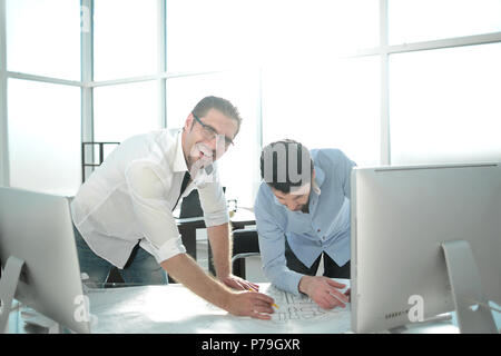 smiling architects work with drawings Stock Photo