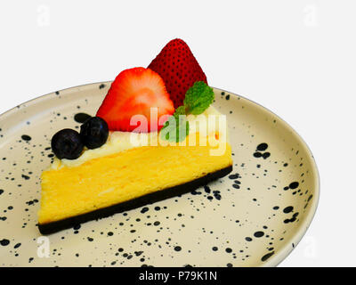 Delicious cheesecake with fresh berries and strawberry on plate isolate on white background. Stock Photo
