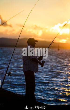 Man fishing in the sunset, fishing rod, sea, silhouette Stock Photo - Alamy