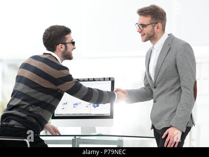 Business associates shaking hands in office Stock Photo