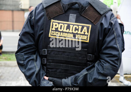Back of a male police officer, uniform of a policeman in Peru, on his back says police squadron green, security concept Stock Photo