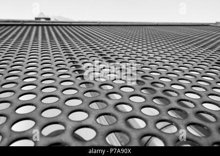 Metal perforated sheet on house background, Clean vs. dirty facade symbol Stock Photo