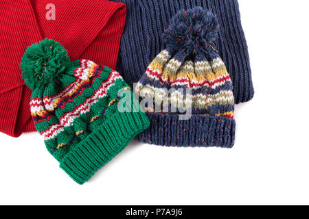 Two bobble hats and scarves isolated against a white background. Stock Photo