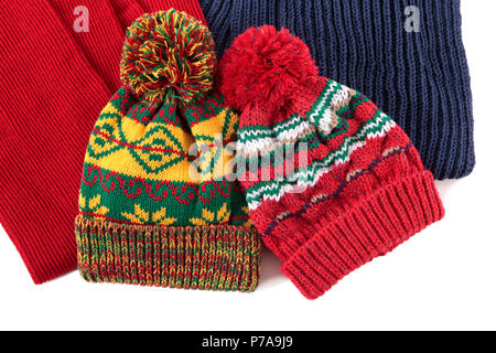 Two bobble hats and scarves isolated against a white background. Stock Photo