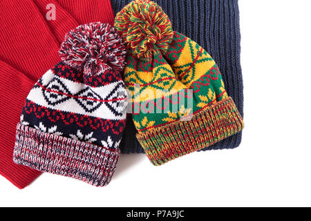 Two bobble hats and scarves isolated against a white background. Stock Photo