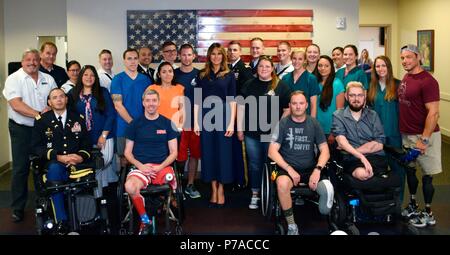 Bethesda, Maryland, USA. 3rd July, 2018. U.S First Lady Melania Trump poses with staff and wounded warriors during a surprise visit to Walter Reed National Military Medical Center July 3, 2018 in Bethesda, Maryland. Credit: Planetpix/Alamy Live News Stock Photo