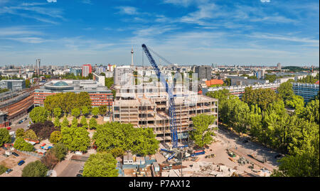 ]Eastern Berlin in Summer. View from above on construction site with crane, television tower on Alexanderplatz and city skyline Stock Photo