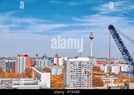 Above view of Eastern Berlin with construction crane, modern buildings, television tower on Alexanderplatz and city skyline in Autumn Stock Photo