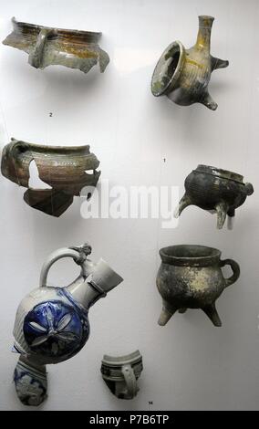 Polish pottery. Fragments of kitchen utensils of three-legged pots and pans and flat bottom pots. 17th-18th century. Archaeological Museum of Gdansk. Poland. Europe. Stock Photo