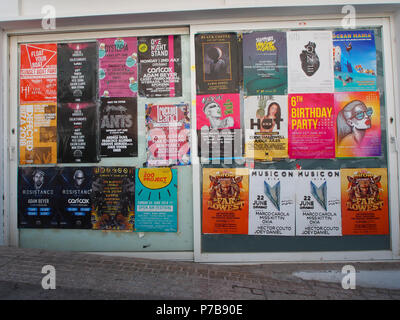 posters advertising nightclubs on a wall in San Antonio bay, Ibiza, spain. Stock Photo