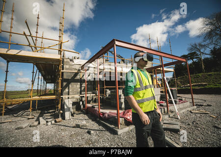 Engineer using VR headset at the construction site Stock Photo