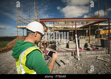 Engineer using digital tablet at the construction site Stock Photo