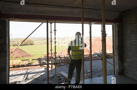 Engineer talking on the phone at the construction site Stock Photo