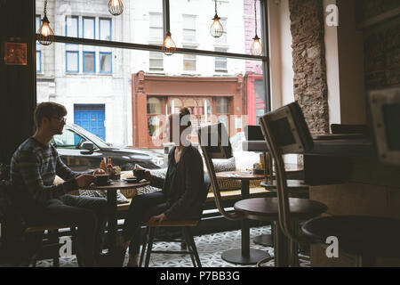 Couple interacting with each other while having coffee Stock Photo