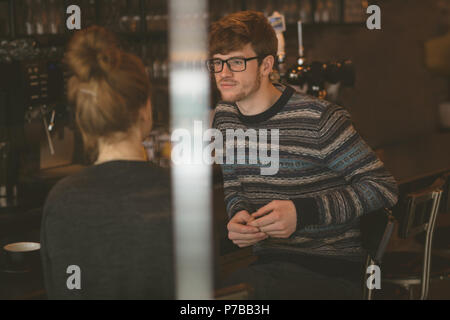 Couple talking to each other in the cafe Stock Photo