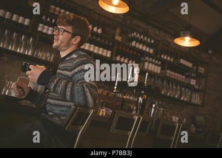 Man having coffee while sitting at the bar counter Stock Photo