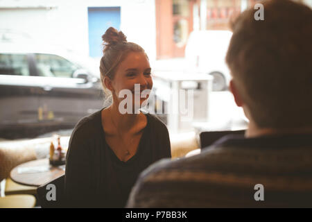Woman talking to man in the cafe