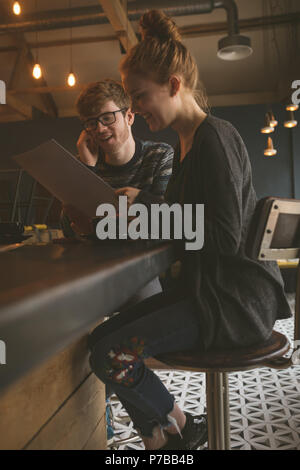Couple checking the menu card at restaurant Stock Photo