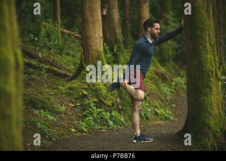 Fit man doing stretching exercise Stock Photo