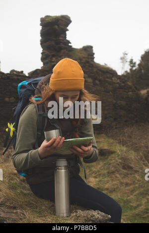 Female hiker reading a map and having a drink Stock Photo