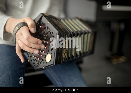 Schoolgirl playing accordion in music school Stock Photo