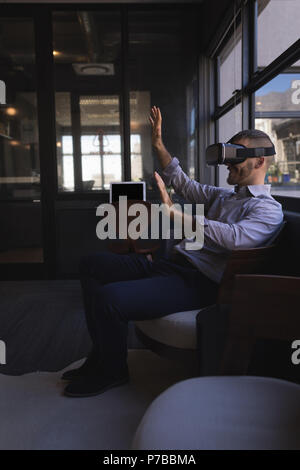 Businessman using virtual reality headset Stock Photo