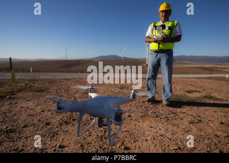 Engineer controlling a drone with a controller Stock Photo
