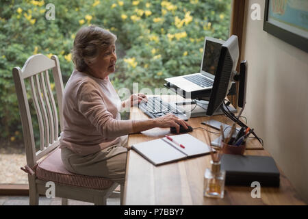 Senior woman using a desktop computer Stock Photo