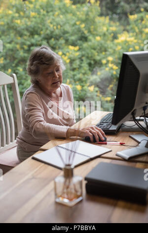 Senior woman using a desktop computer Stock Photo