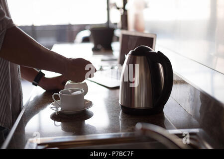 Man preparing coffee in the kitchen at home