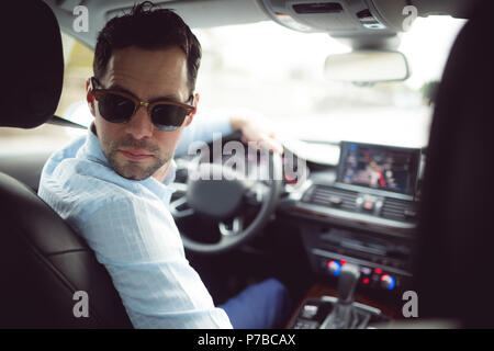 Businessman driving a car Stock Photo