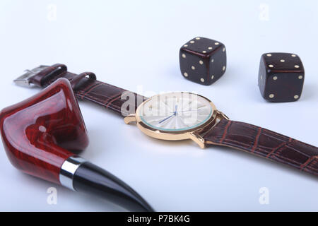 Men's accessories for business and rekreation. Watch, smoking pipe and dice on white background.. Top view composition. Stock Photo