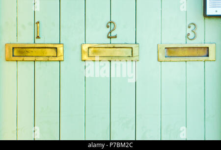 Three letterboxes mounted in a wooden panel Stock Photo
