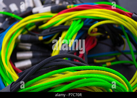 colorful sound and light signal cables on black stage case, shallow focus Stock Photo