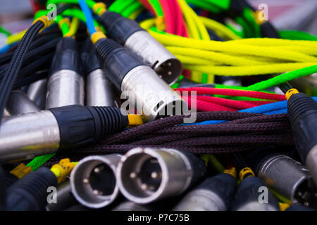 colorful sound and light signal cables on black stage case, shallow focus Stock Photo