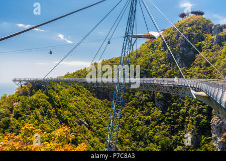 Great scene of the curved pedestrian cable-stayed, single-pylon Langkawi Sky Bridge with a stunning backdrop of two gondolas near the... Stock Photo