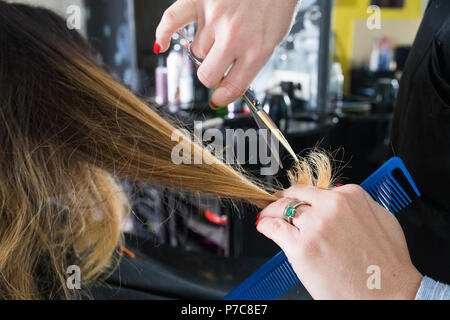 Hairdresser Trimming Ombre Hair With Scissors In Beauty Salon