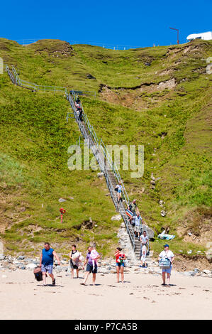 Silver strand beach, people walk down steep steps in Malin Beg, County Donegal, Ireland Stock Photo