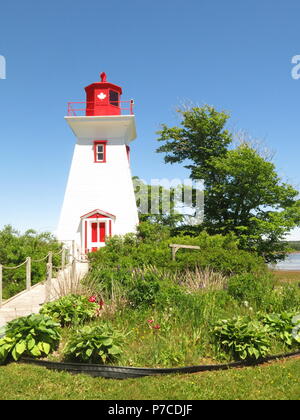 The red and white lighthouse at Victoria Seaport Museum, Victoria-by-the-sea, Prince Edward Island, Canada Stock Photo