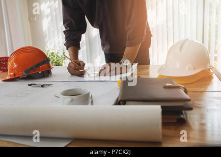 Architect or engineer using pencil and protractor working on blueprint, architectural concept Stock Photo